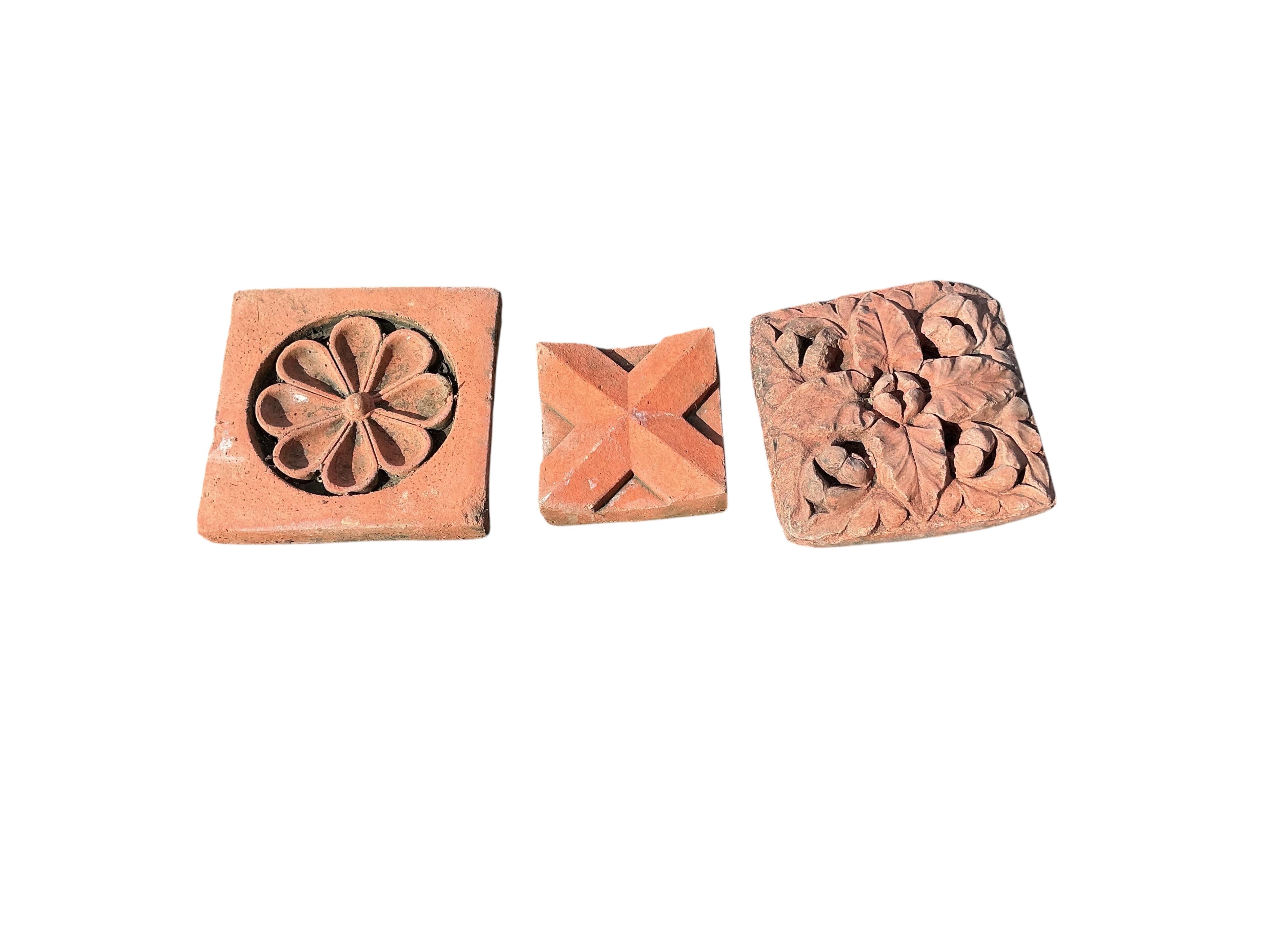 Eleven terracotta tiles, largest 22 x 24cm